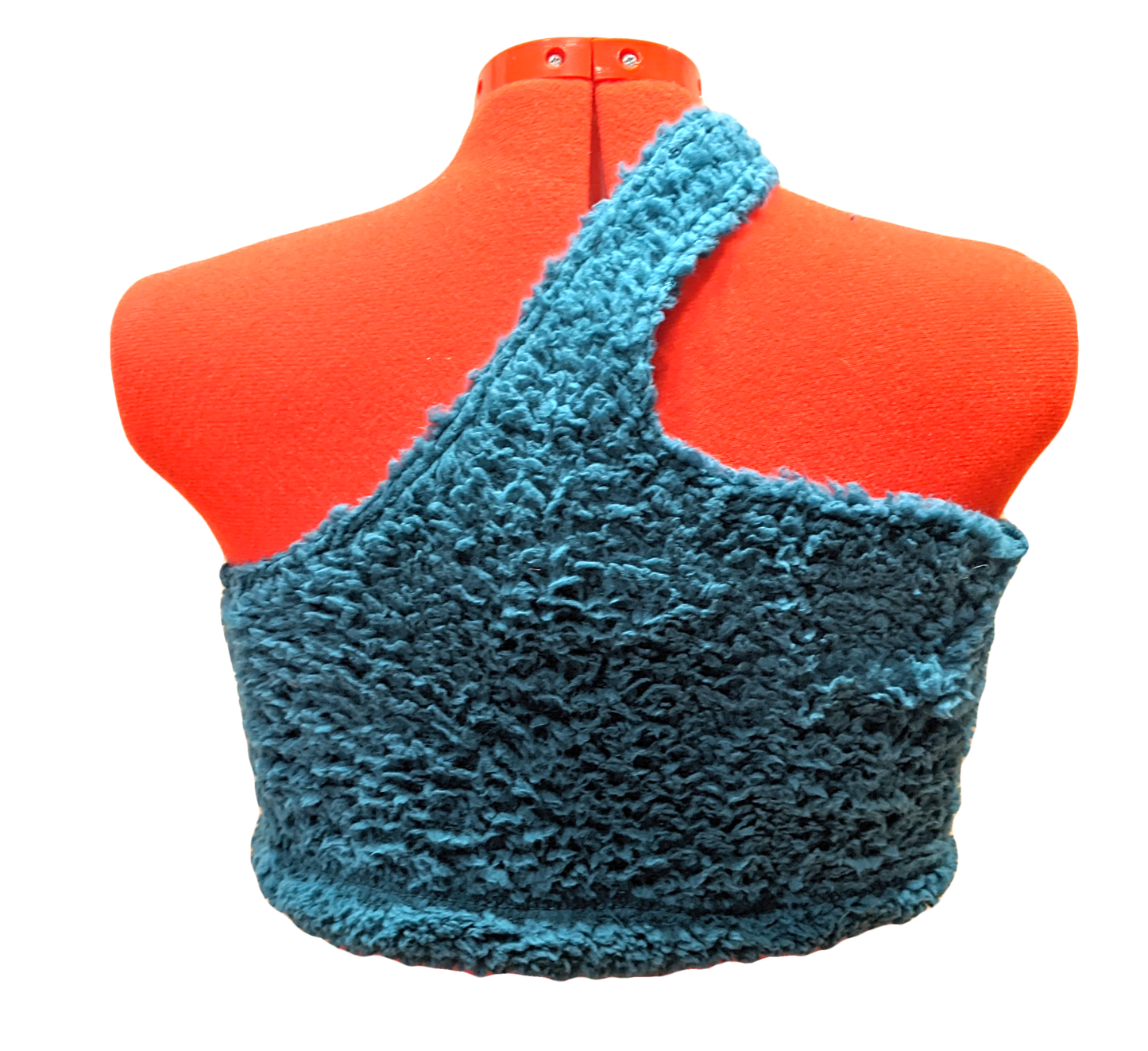 Back of the bralette/tank. Looks a little more blue in this picture. Fluffy blanket texture. Strap goes from one side of the neck to the center of the back, which flares up in the shape of a wave to meet the strap. Slight indents where the stitching lays.