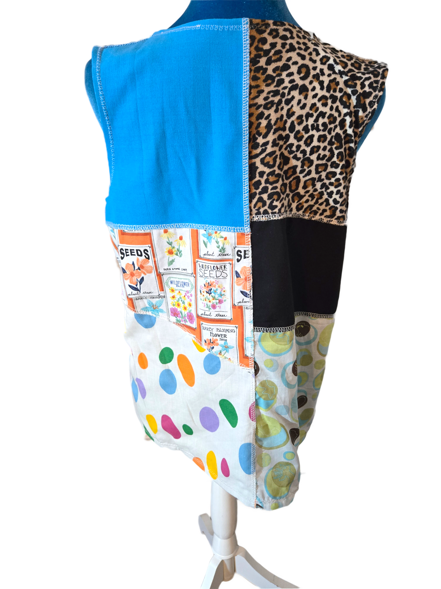 Back view of a tank top with colorful patchwork design on a mannequin against a white background