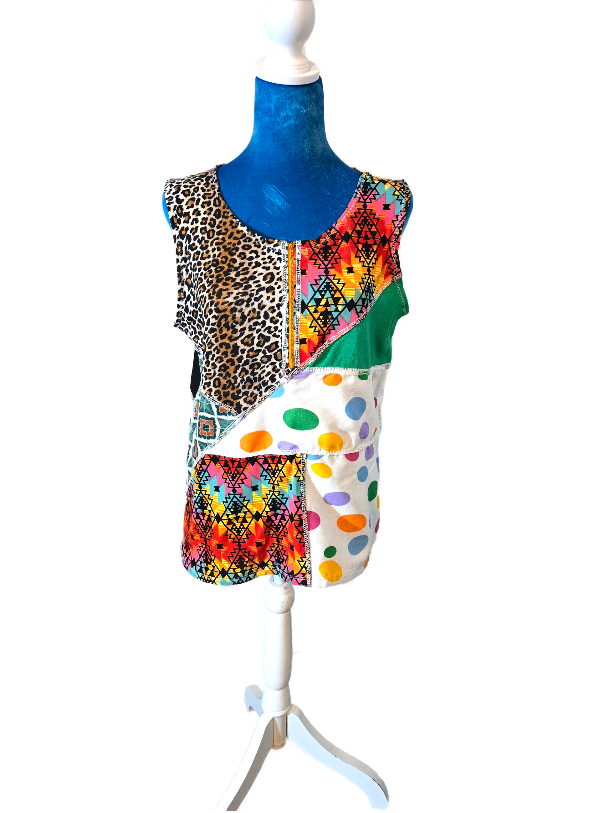 Multicolor patchwork top on a manniquin with a white background.