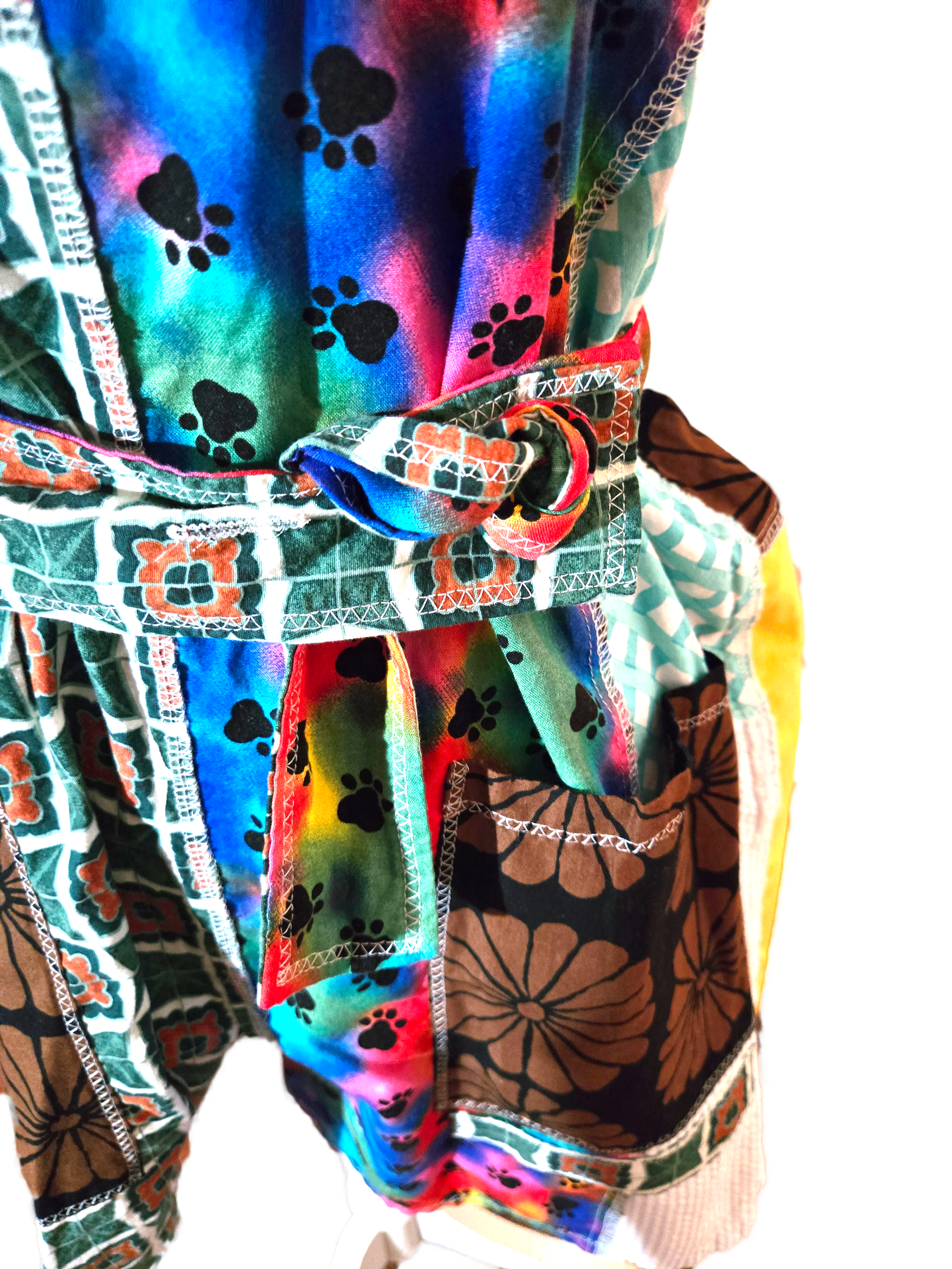 Colorful patchwork romper, zoomed in on the detachable belt. There are also pockets in the background.